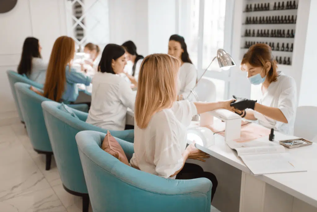 nail salon professionals serving clients in a salon