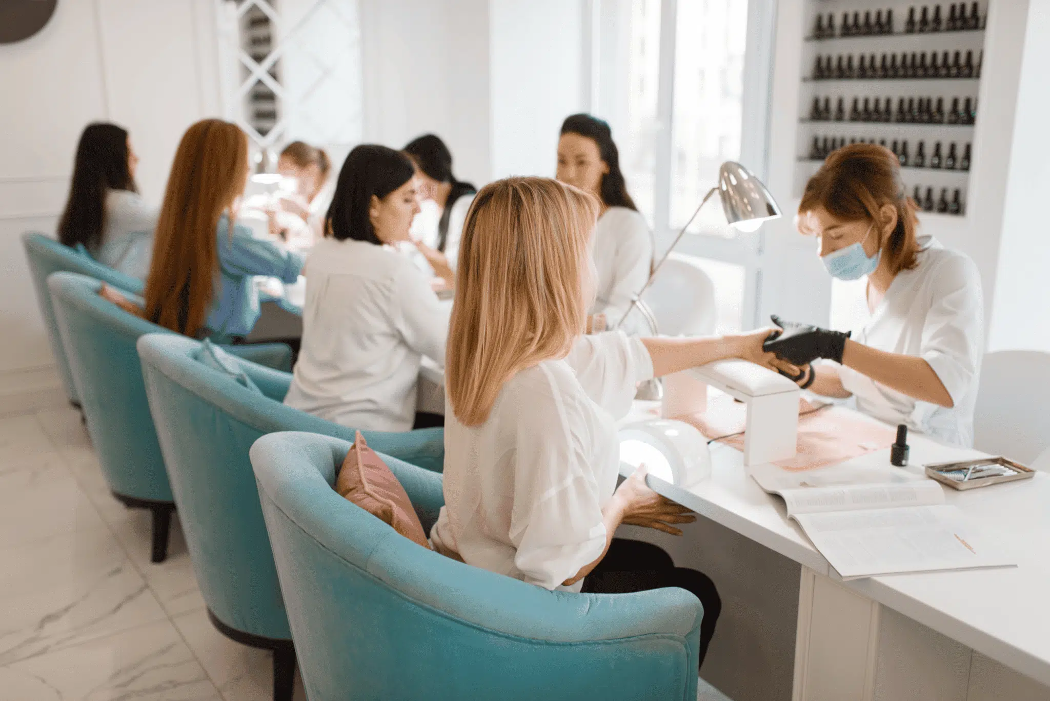 nail salon professionals serving clients in a salon