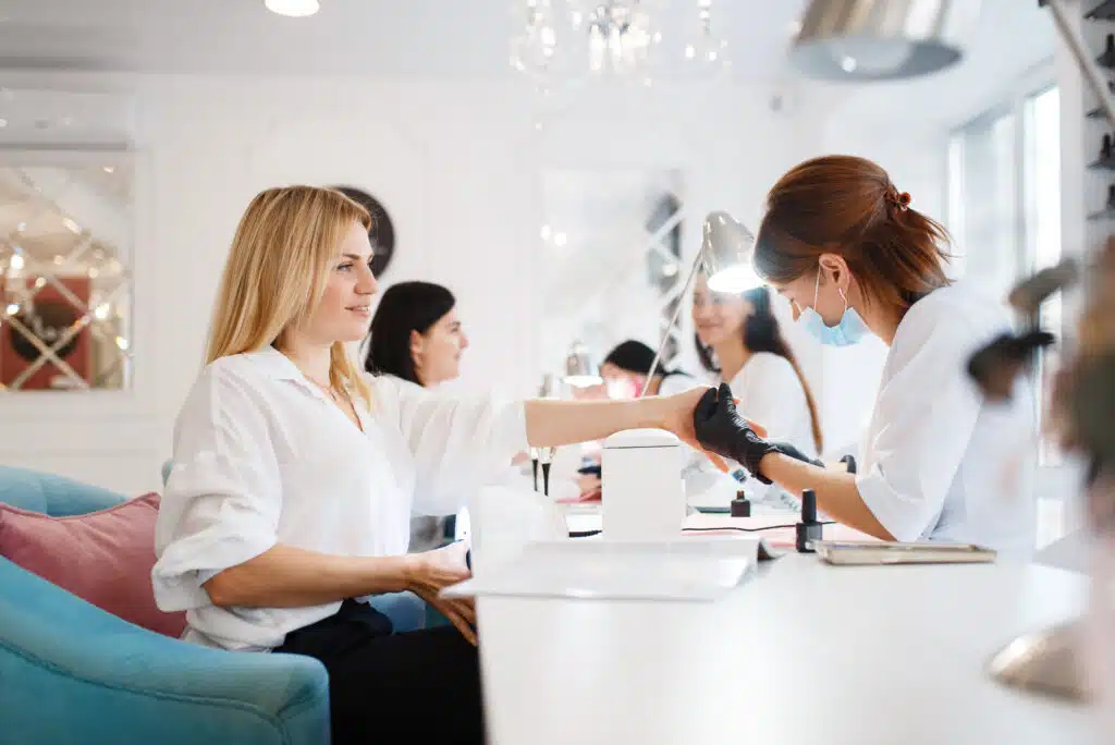 nail technicians at work serving a group of clients