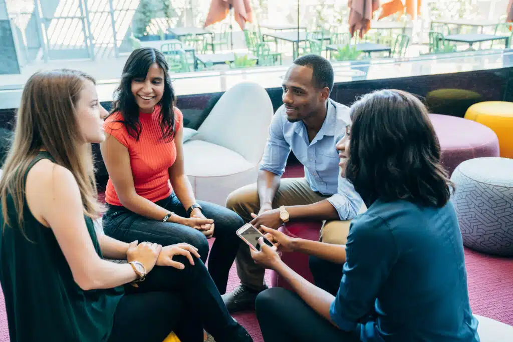 business meeting in lobby of colorful modern office space