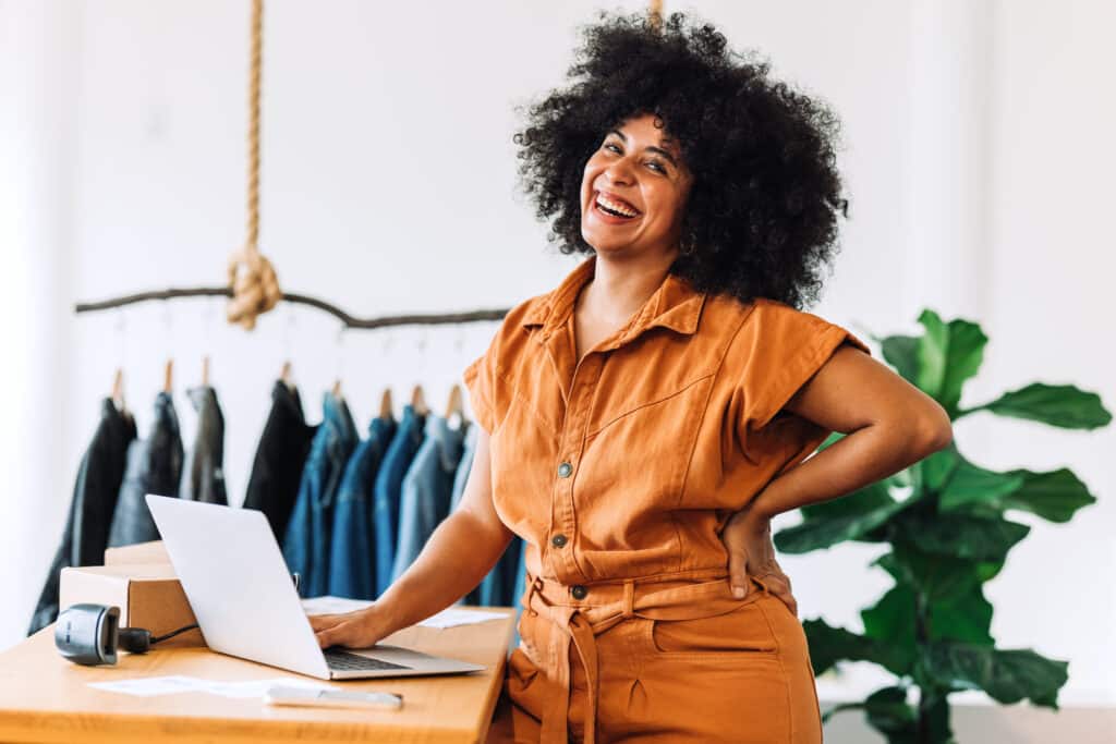 business owner smiling and working with laptop