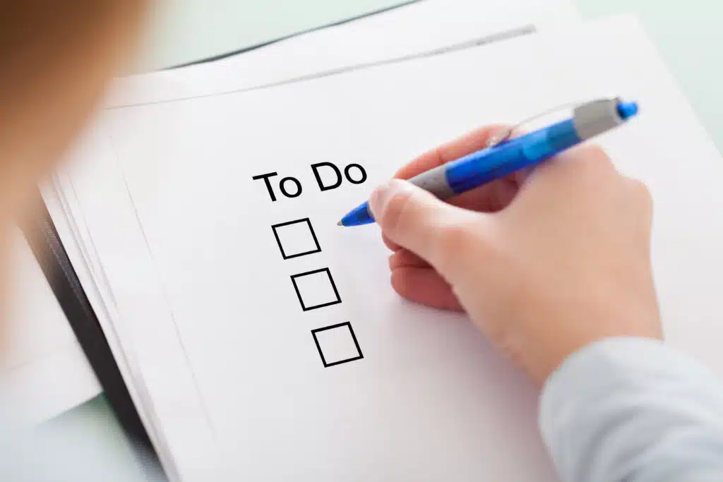 business woman creating a to-do list for the next day of work