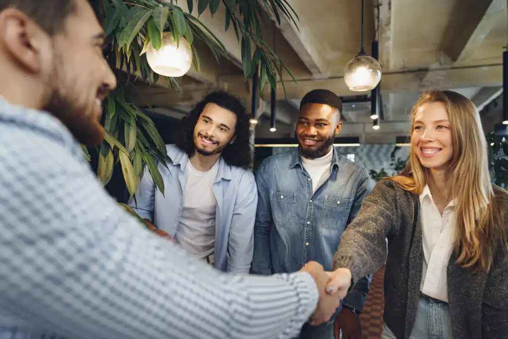 team welcoming new employee first day at work in new job 