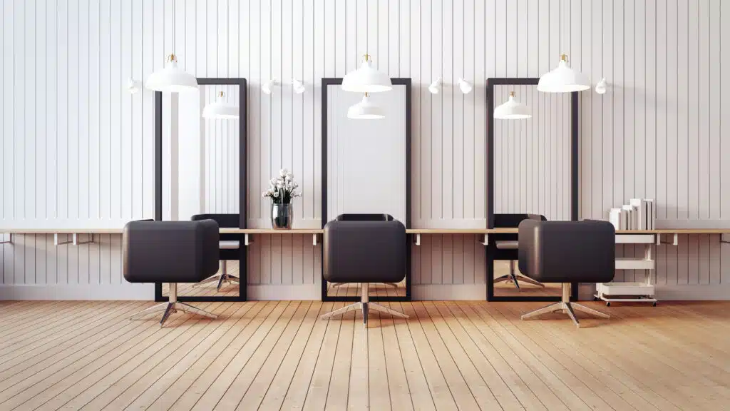 profitable hair salon empty with three chairs and three mirrors and wooden floors and wall