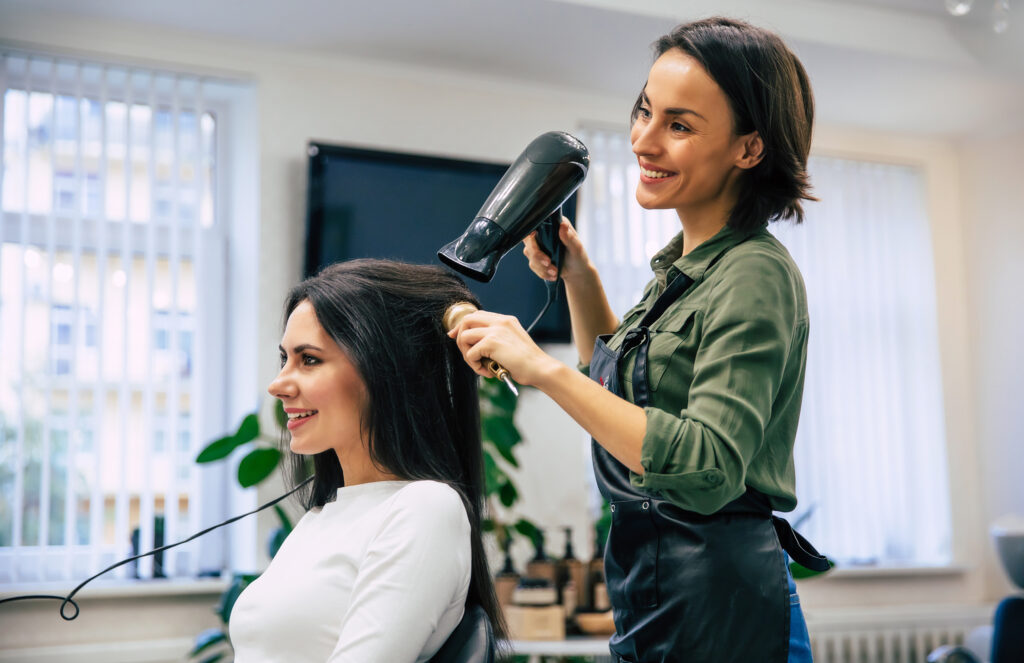 hair stylist caring for clients hair in a hair salon