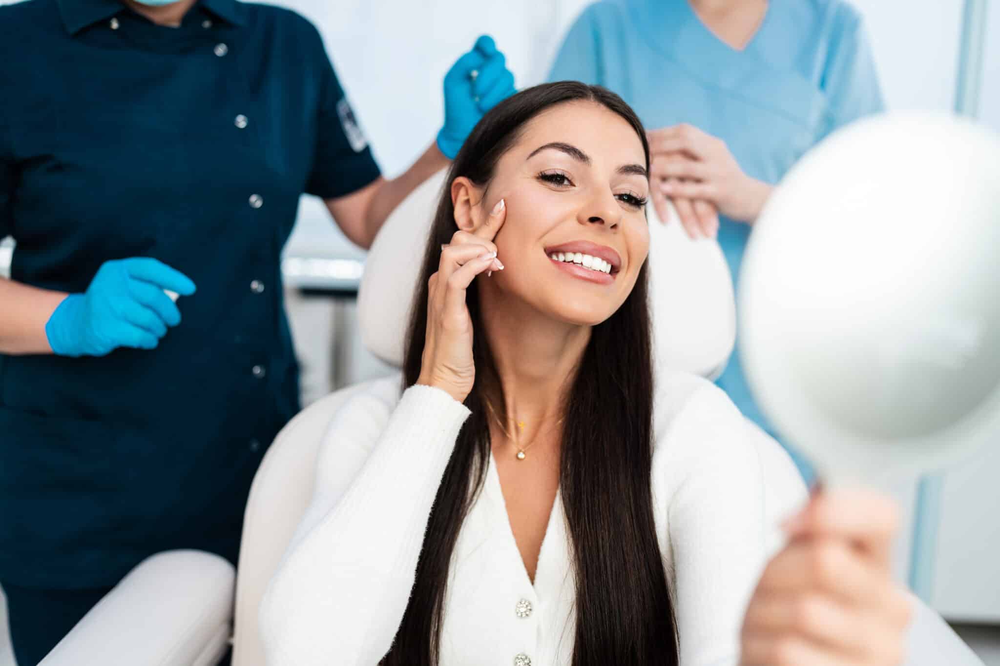 medical spa ideal client looking in the mirror with staff in the background