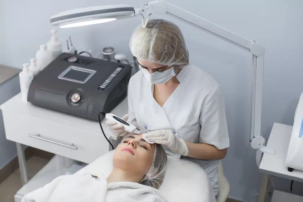 medical spa procedure esthetician working on facial treatment with client