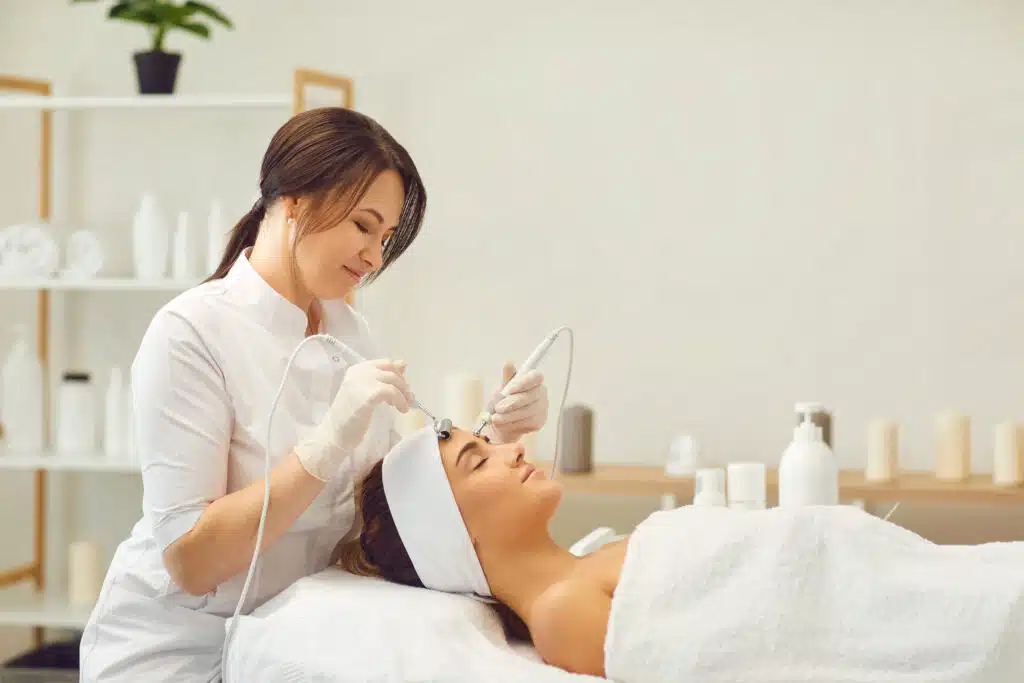 medical spa professional treating clients face with facial procedure