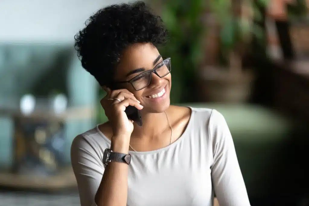 happy smiling african american woman talking on phone