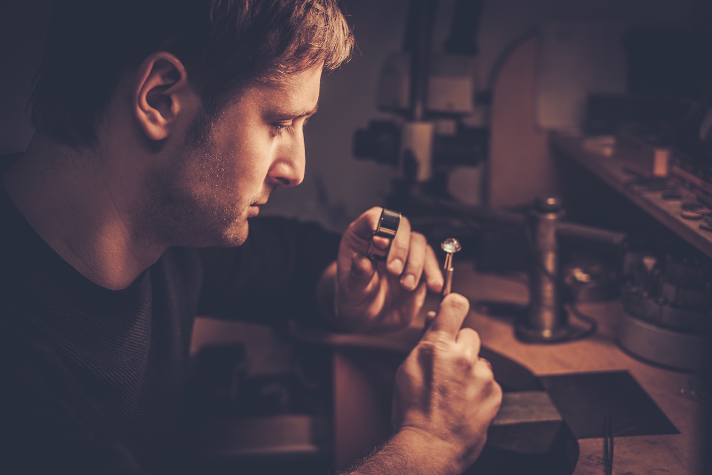 jeweler looking at the ring through microscope jeweler looking at the ring through microscope